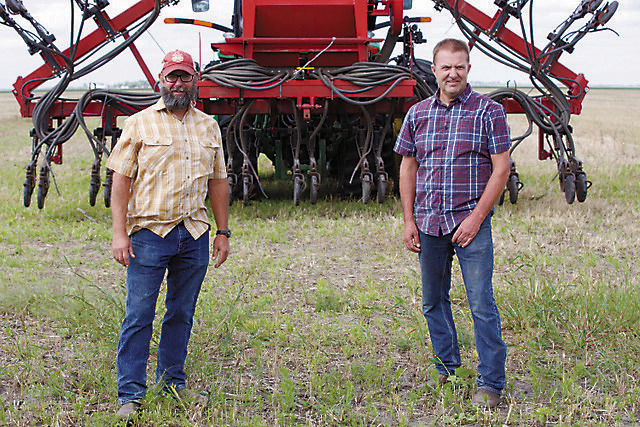 Chris Walberg (left) and Tyler Zimmerman, lifelong friends who have turned to regenerative agriculture together, were featured in a mini-documentary that’s been viewed nearly 600,000 times in the past six months. Photo provided by Kiss the Ground.