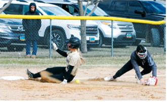 Colbie Furstenau slides safely into third base on April 28 against the Cardinals in Langdon. Photo by Larry Stokke