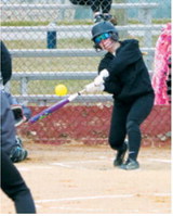Remi Larson connects for a base hit. Photo by Larry Stokke