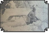 A FAMILIAR PLIGHT, which Langdon residents awoke to Saturday morning was that of finding their cars buried in large snowdrifts. Carlyle Hillstrom is shown here digging his car out in front of the Carl Wild residence. A snowdrift in the background is at roof-level at the John Hannesson residence along Eleventh Avenue. Cavalier County Republican photo / cutline from Thursday, March 10, 1966