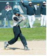 Collin Longtin connects for a base hit during action against the Grafton Spoilers in Pembina. Photo by Larry Stokke