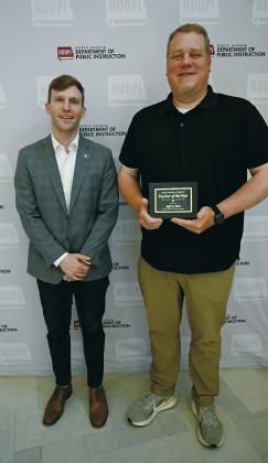 Jeff Moe of North Border School, right, is recognized as the 2026 Pembina County Teacher of the Year by North Dakota Superintendent of Public Instruction Levi Bachmeier during a ceremony in Bismarck. Photo courtesy of the North Dakota Department of Public Instruction. Submitted photo