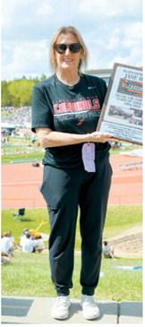 Jane Hart poses with a plaque recognizing her 42 years of dedication to Langdon Area track and field, honoring a coaching career that spanned from 1984 to 2026 and the accomplishments of countless athletes she mentored along the way. Photo by Larry Stokke