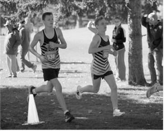 Nolan Pelletier and Micah Crosby run the course at the Rugby Booster Club Invitational on Oct. 3. Crosby finished 37th out of 208 runners. Photo by Larry Stokke
