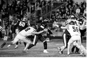 Chase Mench (48) wraps up a Cavalier ball carrier during the Eagles' game Friday, Oct. 16, in Cavalier. Photo by Ashley Ashley Schafer