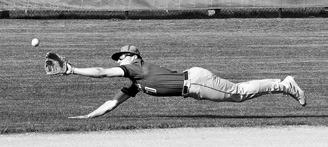 Mason Romfo stretches out, diving to catch the ball against the Spoilers in Langdon on May 13. Photo by Larry Stokke.