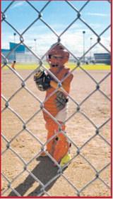 Griffey Bata gets set behind the plate while catching during an 8U baseball game in Cavalier. Submitted photo