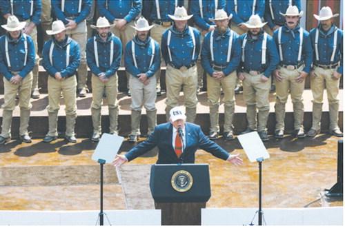 President Donald Trump speaks to a crowd July 1, 2026, at the Burning Hills Amphitheatre in Medora, N.D., in front of people portraying Theodore Roosevelt’s Rough Riders. (Photo by Kyle Martin/For the North Dakota Monitor)