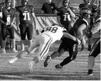 Colten Hein tackles the Hornet ball carrier in Harvey Sept. 4. Photo by Larry Stokke