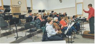 Members of the Langdon Community Band rehearse in the Langdon Area High School band room. Submitted photo