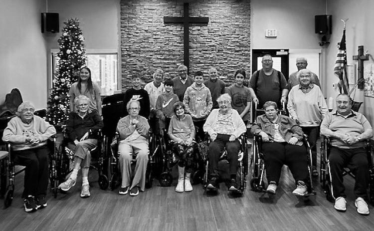 Bob and Crew poses for a photo with residents and sixth graders.