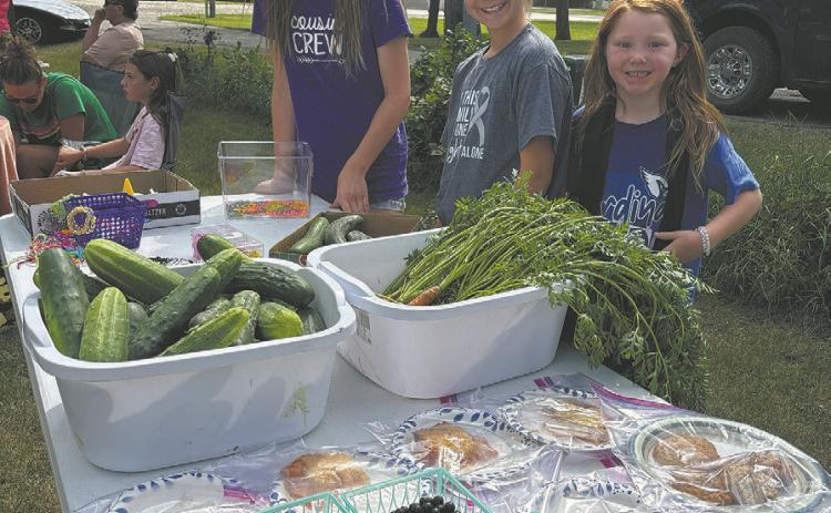 Members of the Chaput family showcase their impressive produce at the farmers market. Borderland Press photo