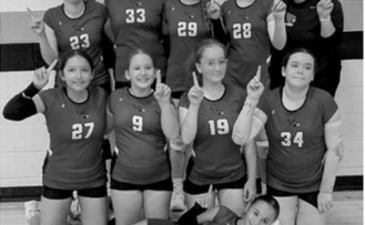 One of Langdon-Munich’s three junior high volleyball teams celebrates after winning its bracket at the Langdon Area Invitational on Saturday, Sept. 12. The tournament was held at Langdon Area High School and the Langdon Activity Center.