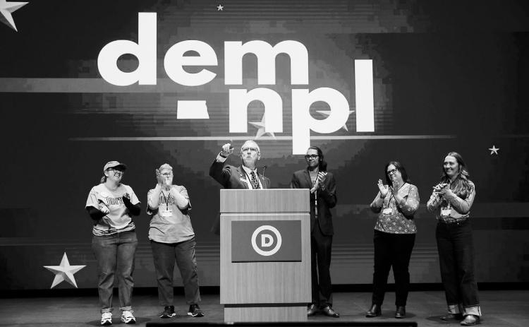 Vern Thompson, center, a former Dem-NPL state lawmaker, speaks during the Dem-NPL state convention in Bismarck on March 7, 2026. Thompson failed to secure the party's endorsement for U.S. House but announced Friday he's running for state agriculture commissioner. (Photo by Kyle Martin/For the North Dakota Monitor)