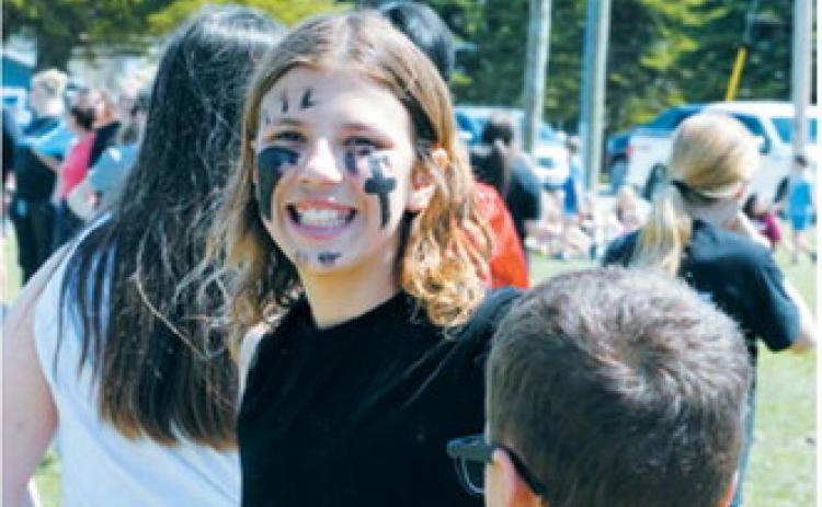Brooklyn Mondor sports game-day face paint as she prepares to take the field during the annual sixth grade vs. teachers kickball game, one of several end-of-the-year activities at Langdon Area Elementary. Photo by Larry Stokke