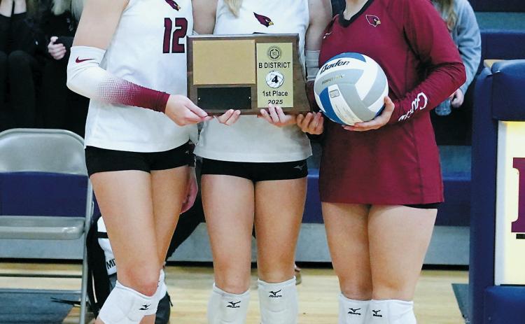 From (L-R) Kemi Morstad, Hilary Haaven, and Raeleigh Ratzlaff accept the 1st place plaque and game ball after taking first place in the District 4 Tournament in Rolla on Nov. 3. Photo by Larry Stokke.