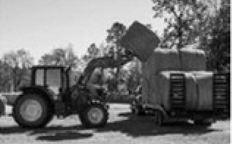 Loads such as seed, fertilizer, equipment and hay bales are subject to vibration, swaying, centrifugal force, inertia, wind and other forces during transit. USDA photo