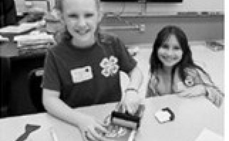 Sign Etching: Ava and Olive personalize their sign. Submitted photo