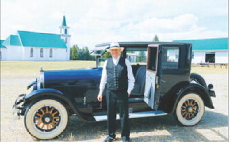 Curtis Olafson portrays G.B. Gunlogson while seated in an antique automobile at the Pembina County Historical Museum on Sunday, Aug. 16. Photo by Larry Stokke