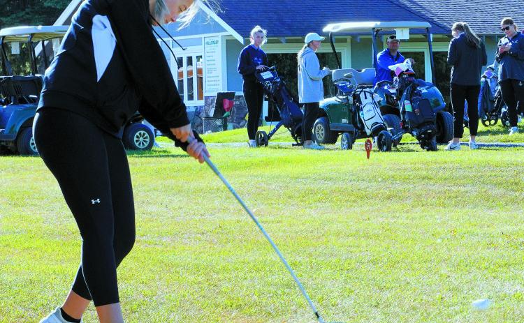 Nadia Lewis tees off at the first golf meet of the year in Park River. Photo by Larry Stokke.