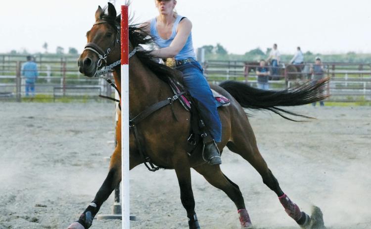 Carmyn LeTexier on her horse Rocket had a great run in the poles class June 10 in Devils Lake. Photo by Larry Stokke.