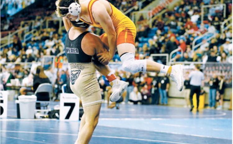 Aiden Werner powers his man off the mat and won his match with a pinfall. Photo by Larry Stokke