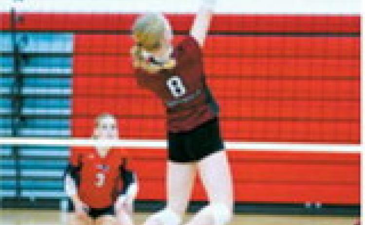Hilary Haaven finds an open spot on the Patriots’ side of the court and sends the ball over the net for a point for the Cardinals. Photo by Larry Stokke