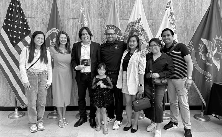 Eamon Alido, a teacher from the Philippines at the Mott-Regent Public School District, receiving an award from state school superintendent Kirsten Baesler (pink) for county teacher of the year in Hettinger County in 2024. Many teachers on J-1 visas like Alido would rather get H-1B visas because they offer both a longer stay and a potential path to citizenship. J-1 visa holders can stay three years and a maximum of five if extensions are given, before returning to their home country.