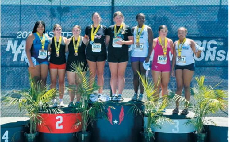 Fenja Lawson stands atop the first-place podium with fellow medalists in the girls 15-16 discus competition at the USATF National Junior Olympic Track &amp; Field Championships. Lawson edged the runner-up by 2 inches to claim the national title. Submitted photo