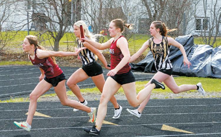 PCN teammates Megan Misson, Jaylynn Stegman, Marlie Stremick and Addelyn Manley racing against the Cardinals team, Meggy Hetletved, Meredith Romfo, Drew Rostvet and McKenna Schneider. The Cardinals would win by a second in the 4X100 relay. Photo by Larry Stokke.
