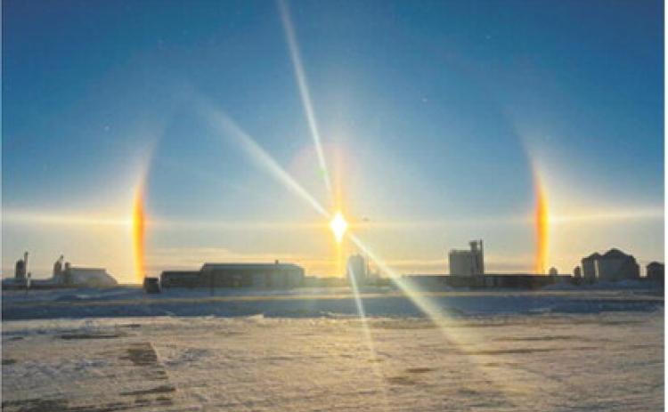 Sun dogs and a solar halo form around the sun as frigid temperatures create ice crystals in the atmosphere over the area. Photo by Rachelle Fetsch