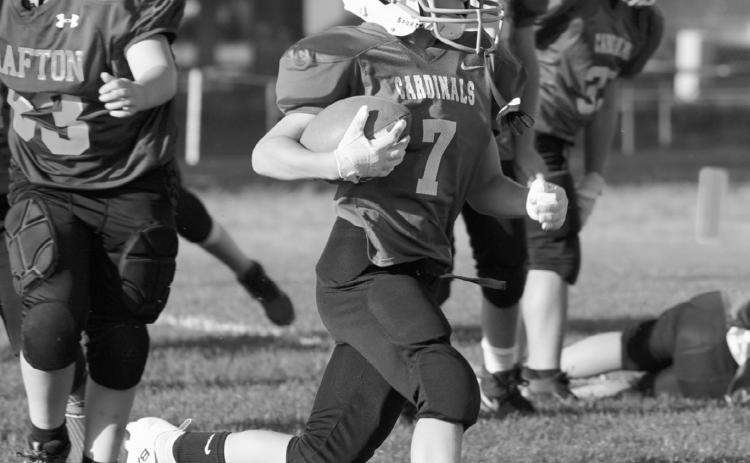 Cardinal fourth- through sixth-grade football players take the field against Grafton on Aug. 27 as part of the Cardinal Elementary Sports Association program. Photo by Larry Stokke