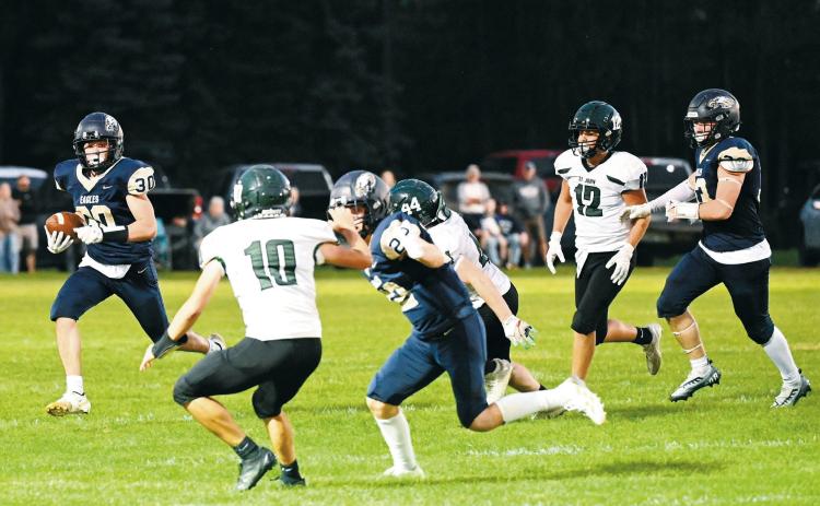 Brody Berg runs wide for a gain on the play in the North Border Eagles Homecoming game on Sept. 26. Photo by Ashley Schafer.