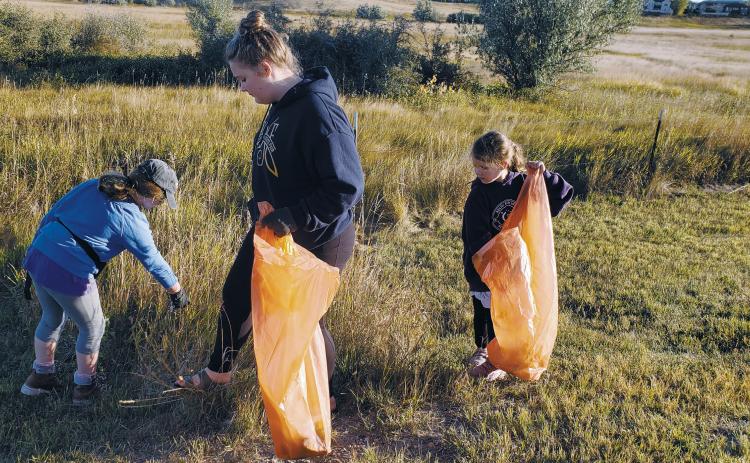 Members from the Clever Clovers 4-H Club in Williams County pick up trash for “Clean Williston,” a community service project for the Healthy North Dakota 4-H Club challenge. (NDSU photo)