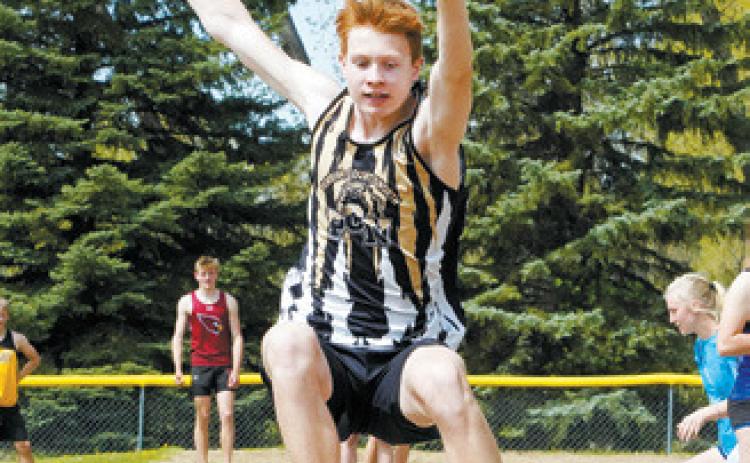 Garrett Willits competing in long jump. Photo by Larry Stokke.