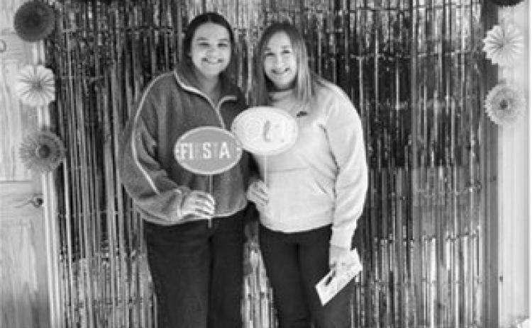 Josie Muhs and Jordyn Tetrault enjoy the photobooth at Dahl Trucking.