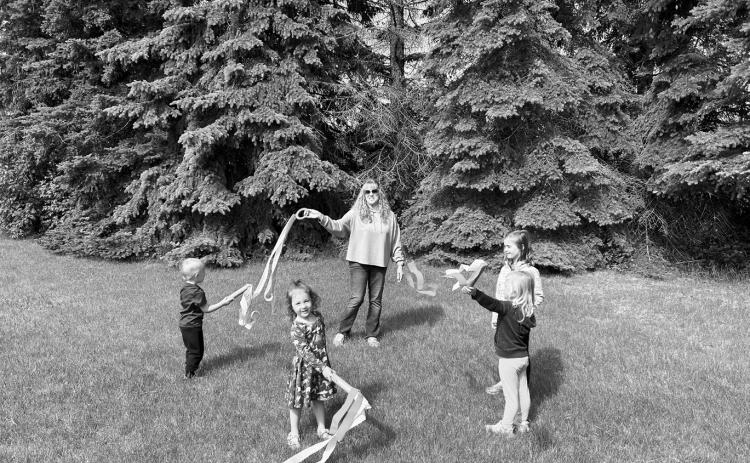 Children use colorful ribbons during a movement activity set to Latin music as part of Lisa Schuler’s summer music classes. The classes introduce young learners to music through movement, rhythm and hands-on activities.