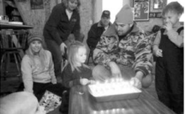 A perfectly imperfect photo taken years ago with a digital camera captures a birthday celebration with my daughter and family. The lighting, the people and the moment take me right back to that day — a reminder that the best photos aren't always perfect, but the memories they hold are priceless.