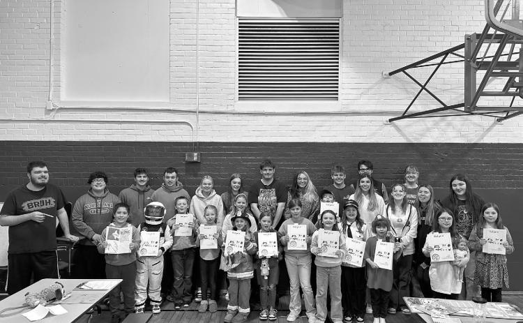 Second graders share their book “When I Grow Up” with graduating seniors during career day at North Border School in Walhalla, creating a full-circle moment as seniors reflected on the same assignment they completed nine years earlier. Submitted photo