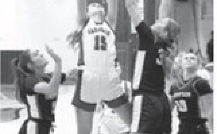 Taya Feist drops one in, gets fouled, and adds a free throw for a 3 point play. Photo by Larry Stokke.