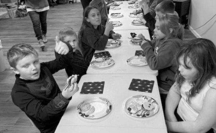 Kids enjoying their snacks at Story Hour.