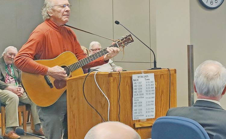 Chuck Suchy, a Mandan Resident, preforms “Dancing Dakota” at a committee hearing on Jan. 30. The committee recommended a Do Pass on HB 1397 which would designate the song as the state’s official waltz. Suchy is also under consideration to become the official state troubadour. Photo by Ann Estvold, NDNA.