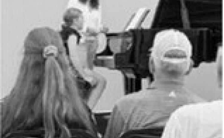 Brooke Gemmill participates in a master class led by Dr. Helen Marlais during the Popplers Music Competition in Grand Forks.