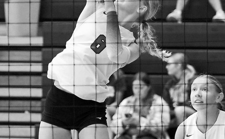 Hilary Haaven spikes the ball over the net in Thompson for a point. Photo by Larry Stokke.
