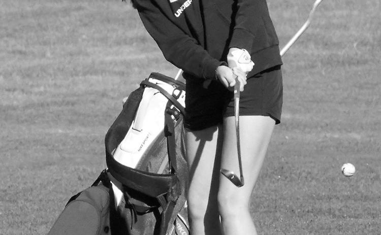 Lily Zimmer with a chip shot up onto the green in Lakota on Aug. 22 where she finished the day with a score of 103. Photo by Larry Stokke.