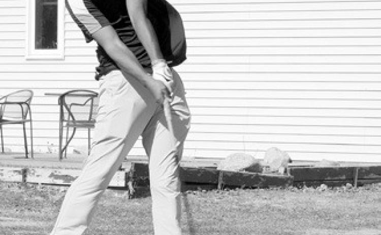 Gabe Symington tees off at the Langdon Invitational on April 25. Photo by Larry Stokke.