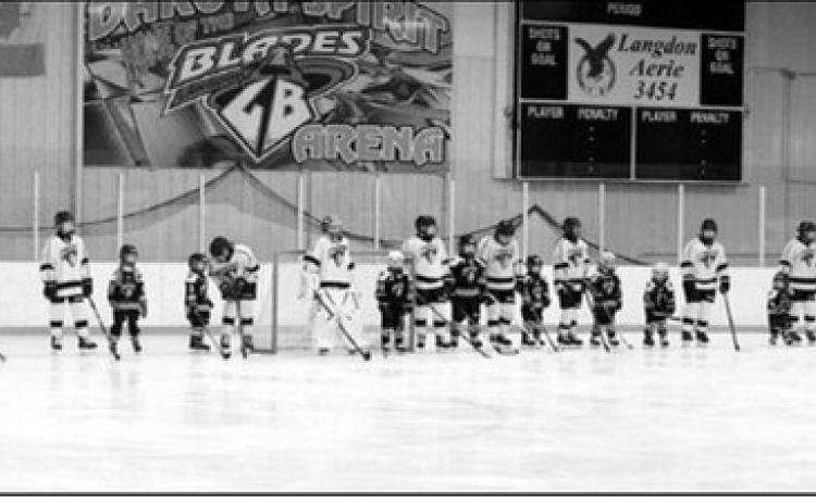 Players with their little buddies at the start of the game. Photo by Larry Stokke