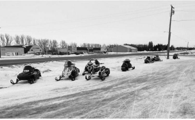 Snowmobiles are parked outside At the Hop in Langdon during the 2025 Fun Run event. Submitted photo