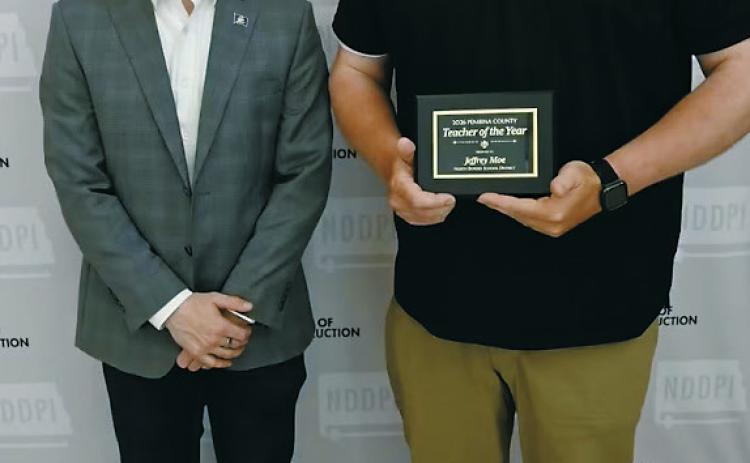 Jeff Moe of North Border School, right, is recognized as the 2026 Pembina County Teacher of the Year by North Dakota Superintendent of Public Instruction Levi Bachmeier during a ceremony in Bismarck. Photo courtesy of the North Dakota Department of Public Instruction. Submitted photo
