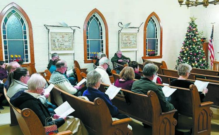 Attendees filled the pews last year for the Carol Sing at the beautifully decorated Hallson Church.